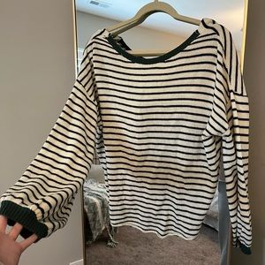White sweater with black stripes and green detail at neckline and sleeve line